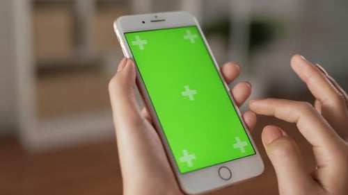 Closeup of hand woman using smartphone with green screen