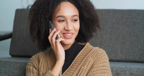 Smiling Woman Talking on Smartphone at Home