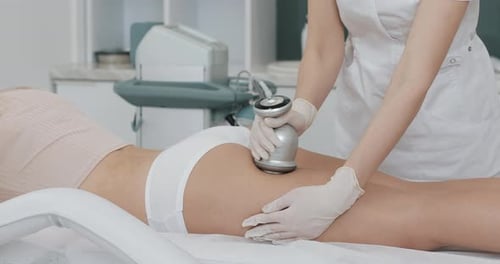 Woman Receiving Thigh Treatment at Clinic