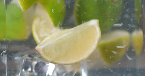 Lime Wedges and Ice in Glass