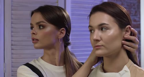 Two Young Women Indoors Posing for Camera
