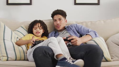 Father and Child Playing Video Games at Home