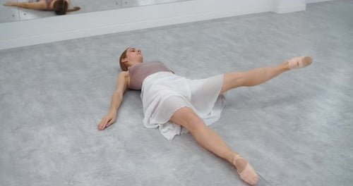 Ballerina Does Warm Up Exercises on the Floor of the Dance Room Ballet School Rehearsal