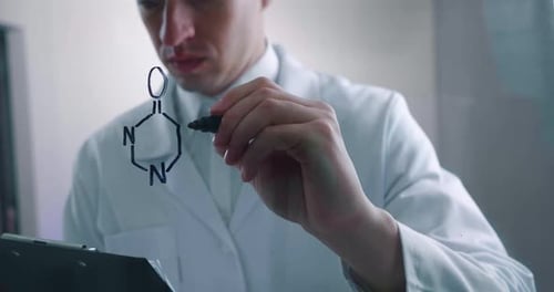 Scientist Writes Caffeine Chemical Formula on Glass