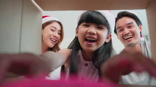 Happy Family Opening Christmas Gift Together