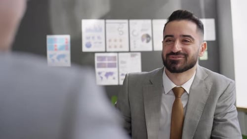 Bearded Man in Suit Talks in Office, Shakes Hand