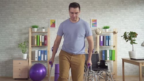 Man with Leg Cast Using Crutches to Walk