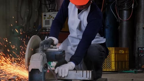 Industrial Metal Saw Sparks in Factory Workshop