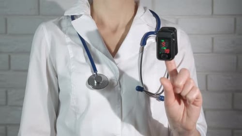 Healthcare Worker with Pulse Oximeter on Finger