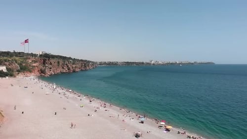 Amazing coastline with mountain hills and pebble beach at sunny summer day.