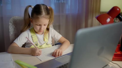 Girl Doing Homework at Desk with Laptop