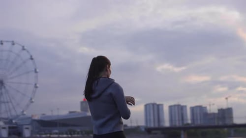 Sportive Woman Running in City and Using Smartwatches