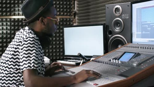 Sound Engineer Mixing Music at Recording Studio