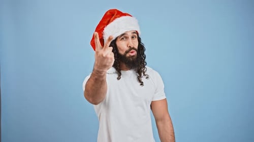 Happy Man Celebrates Christmas in Santa Hat