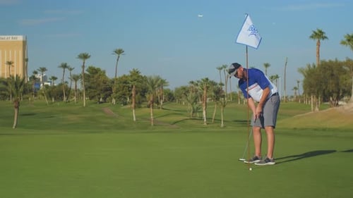 Man putting on golf green