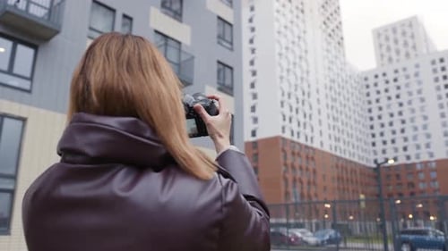 Woman Taking Photos of Modern Apartment Buildings