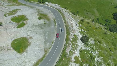 Drone Chasing Red Vehicle on Windy Mountain Road