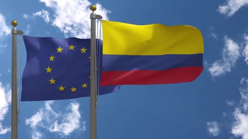 European Union and Colombia Flags Waving in Blue Sky