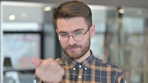 Young Adult Pointing and Beckoning at Camera