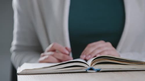 Closeup Unrecognizable Girl Student Sitting at Table at University Learning Lecture Reading Textbook