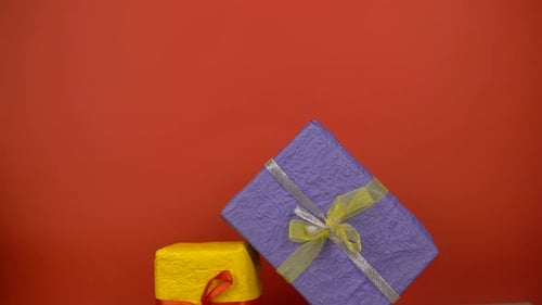 Hand Stacking Colorful Wrapped Gifts for a Birthday