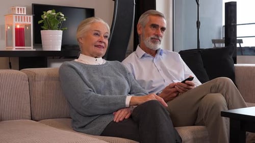 Senior Couple Relaxing Together on Sofa at Home