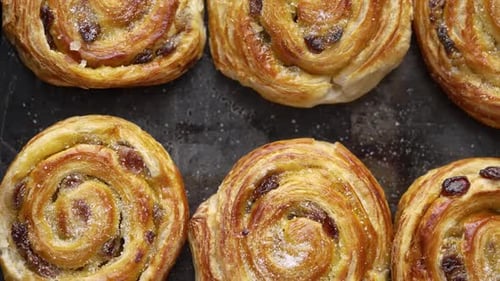 Fresh Raisin Buns on Baking Sheet