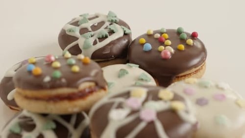 Glazed and stuffed cookies with sprinkles close-up 4K 2160p 30fps UltraHD tilting footage - Slow ti