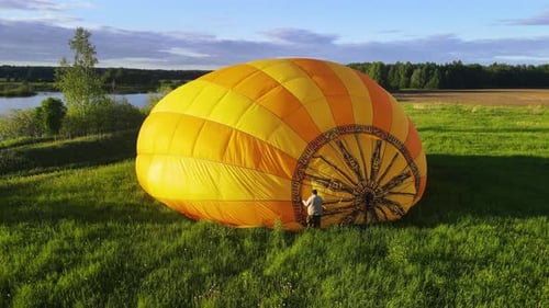 Yellow Hot Air Balloon on Grassy Field