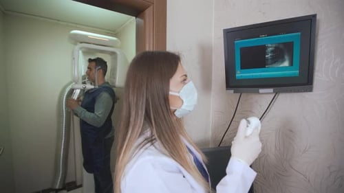 Dentist taking dental x-ray.