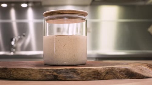 Sourdough Starter in Glass Jar on Cutting Board