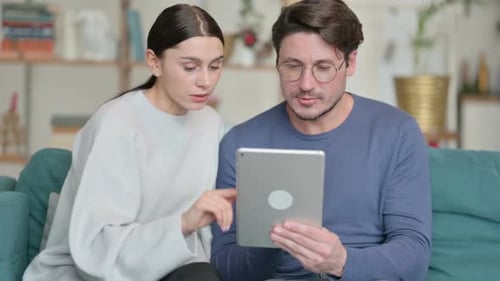 Woman and Man Using Tablet at Home Together