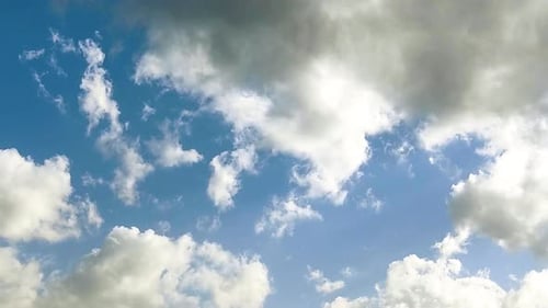 Clouds Drifting Across Bright Blue Sky