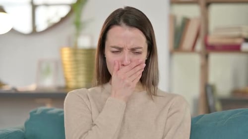 Woman Coughing and Covering Mouth Indoors