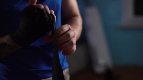 Man Wrapping Hands with Black Boxing Wrap