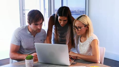 Executives discussing over laptop during a meeting 4k