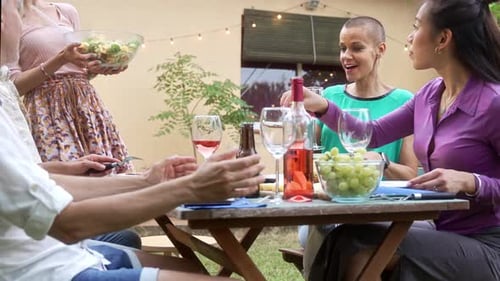 Adults Share Meal and Conversation at Outdoor Table