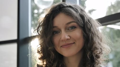 Young Woman Smiling Portrait in Natural Light Indoors