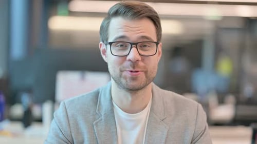 Man Talking and Waving in the Office