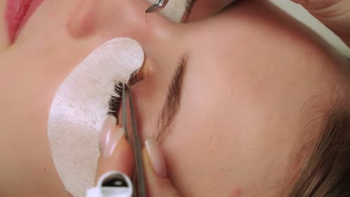 Beautician Applies Individual Lash Extensions in Close Up