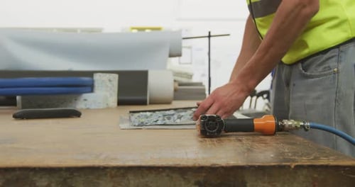 Men Working With Upholstery Staple Gun in Factory