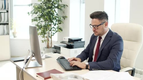 Businessman Working on Computer in Office