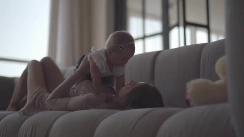 Mother and Baby Bonding on a Couch Indoors