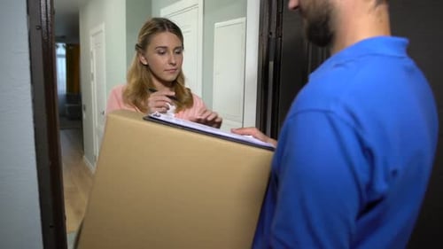 Courier Giving Cardboard Box to Woman Signing Delivery Order, Internet Shop
