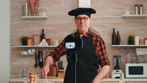 Portrait of Positive Chef Recording Vlog in Kitchen