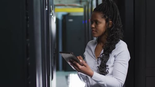 Young Adult Woman Uses Tablet in Server Room