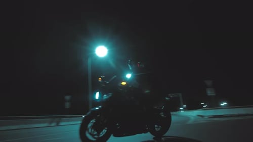 A Man Enters a Turn on a Sports Motorcycle and Picks Up Speed