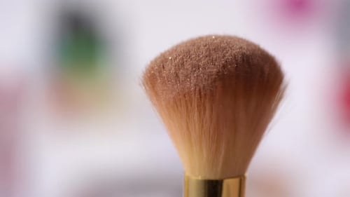 Shimmer Powder Being Blown off Makeup Brush