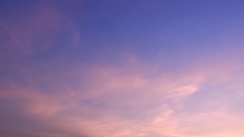 Pastel Clouds Drifting in a Pink and Purple Sky