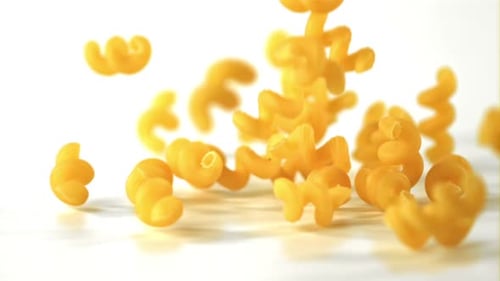 Super Slow Motion Kavatappi Dry Pasta Falls on the Table